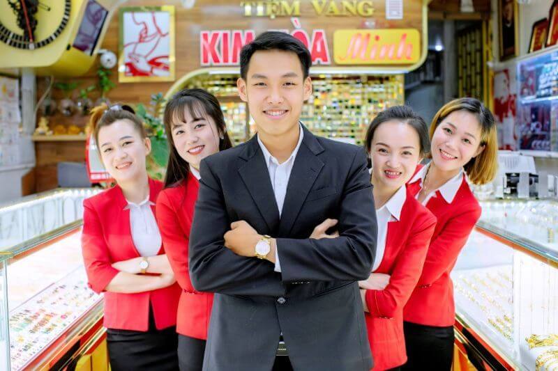 nhân viên tiệm vàng chụp ảnh tại cửa tiệm